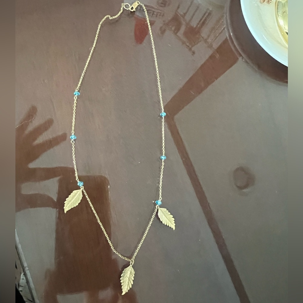 Gold designer necklace with feathers and blue beads. Vintage.